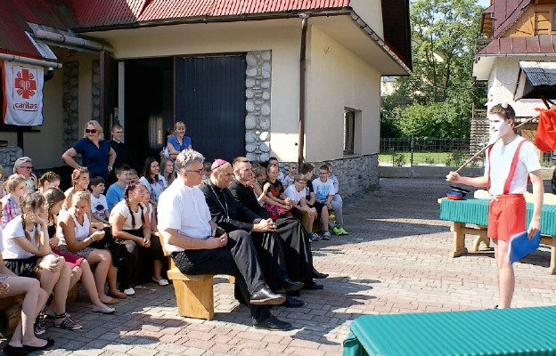 Bp Grzegorz Kaszak ogląda występ w czasie odwiedzin jednego z wakacyjnych
turnusów dzieci i młodzieży naszej diecezji