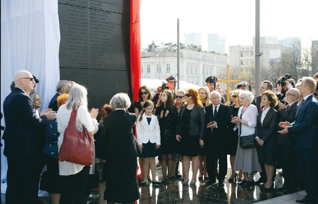 Pomnik, przykryty  biało-czerwoną  flagą,  został  odsłonięty  przez  przedstawicieli  rodzin  smoleńskich